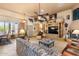 Bright living room with a fireplace, TV, and comfortable seating near a door at 32826 N 54Th St, Cave Creek, AZ 85331