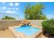 Charming backyard water feature with stone accents and lush landscaping for a serene setting at 32826 N 54Th St, Cave Creek, AZ 85331
