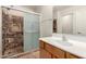 Cozy bathroom with walk-in shower, decorative stone tile, and modern fixtures at 36538 W La Paz St, Maricopa, AZ 85138