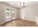 Cozy dining area featuring tile floors, a stylish light fixture, and access to the backyard at 36538 W La Paz St, Maricopa, AZ 85138