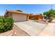 Inviting single-story home featuring a two-car garage and low maintenance desert landscaping at 36538 W La Paz St, Maricopa, AZ 85138