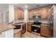 Bright kitchen with stainless steel appliances, wooden cabinets, and lots of natural light at 36538 W La Paz St, Maricopa, AZ 85138