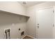 This laundry room has extra storage, shelving, and washer and dryer hookups at 36538 W La Paz St, Maricopa, AZ 85138