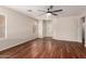 Bright living room with hardwood floors, ceiling fan, and abundant natural light at 36538 W La Paz St, Maricopa, AZ 85138