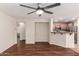 Open living area with hardwood floors, ceiling fan, and seamless access to the kitchen at 36538 W La Paz St, Maricopa, AZ 85138