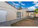 Exterior view of a home with a private backyard, patio area, sliding glass doors and a white entry door at 4016 W Royal Palm Rd, Phoenix, AZ 85051