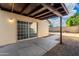 Exterior view of a home with a private backyard, patio area, sliding glass doors and an open beam covered area at 4016 W Royal Palm Rd, Phoenix, AZ 85051