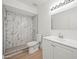 Bathroom featuring modern finishes, a marble-tiled shower, and vanity with white cabinets at 4016 W Royal Palm Rd, Phoenix, AZ 85051