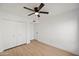 Bedroom featuring wood floors, a ceiling fan, and a closet for ample storage at 4016 W Royal Palm Rd, Phoenix, AZ 85051