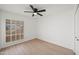 Bright bedroom with wood floors, a ceiling fan, shuttered windows and a fresh, clean aesthetic at 4016 W Royal Palm Rd, Phoenix, AZ 85051