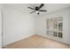 Bright bedroom with wood floors, a ceiling fan, shuttered windows and a fresh, clean aesthetic at 4016 W Royal Palm Rd, Phoenix, AZ 85051