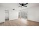 Bright bedroom featuring wood floors, a ceiling fan, shuttered windows, and a closet for ample storage at 4016 W Royal Palm Rd, Phoenix, AZ 85051