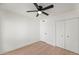 Bedroom featuring wood floors, a ceiling fan, and a closet for ample storage at 4016 W Royal Palm Rd, Phoenix, AZ 85051