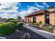 Exterior view of a community clubhouse with a red tile roof, brick facade, and desert landscaping at 4016 W Royal Palm Rd, Phoenix, AZ 85051