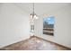 Dining area features a chandelier and a large window that provides ample natural light at 4016 W Royal Palm Rd, Phoenix, AZ 85051