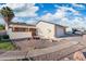 Exterior of home showcasing desert landscaping, white siding and an attached two car garage at 4016 W Royal Palm Rd, Phoenix, AZ 85051