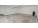 A spacious two-car garage with a concrete floor, white walls, and overhead door with an automatic opener at 4016 W Royal Palm Rd, Phoenix, AZ 85051