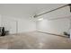 A spacious two-car garage with a concrete floor, white walls, and doors on the back wall at 4016 W Royal Palm Rd, Phoenix, AZ 85051