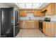 Kitchen featuring natural wood cabinets, modern appliances, and granite countertops at 4016 W Royal Palm Rd, Phoenix, AZ 85051