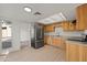 Spacious kitchen with wood cabinets, laminate countertops, and stainless steel refrigerator at 4016 W Royal Palm Rd, Phoenix, AZ 85051
