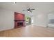 Living room showcasing a red fireplace, wood floors, and sliding glass doors to the yard at 4016 W Royal Palm Rd, Phoenix, AZ 85051