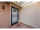 Covered outdoor patio featuring a secured, decorative gate and tiled floor at 4016 W Royal Palm Rd, Phoenix, AZ 85051