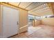 White entry door to a covered outdoor patio featuring tiled floor and white ceiling shade at 4016 W Royal Palm Rd, Phoenix, AZ 85051
