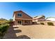 Inviting back exterior with covered patio and low maintenance yard at 4031 W Lone Cactus Dr, Glendale, AZ 85308
