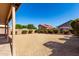 Spacious backyard featuring low maintenance gravel, mature shrubs, and block fence for privacy at 4031 W Lone Cactus Dr, Glendale, AZ 85308