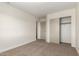 Bedroom featuring neutral walls, carpet flooring, and a closet for ample storage space at 4031 W Lone Cactus Dr, Glendale, AZ 85308