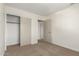 Bedroom featuring neutral walls, carpet flooring, and a closet for ample storage space at 4031 W Lone Cactus Dr, Glendale, AZ 85308