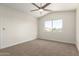 Spacious bedroom with neutral walls and carpet flooring and a ceiling fan at 4031 W Lone Cactus Dr, Glendale, AZ 85308