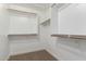 Walk-in closet with carpet flooring and wooden rods for easy organization and accessibility at 4031 W Lone Cactus Dr, Glendale, AZ 85308