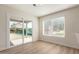 Bright dining area featuring wood-style floors and sliding glass door to the backyard at 4031 W Lone Cactus Dr, Glendale, AZ 85308