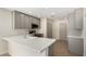 Bright kitchen with modern gray cabinets, stainless appliances, and quartz countertops at 4031 W Lone Cactus Dr, Glendale, AZ 85308
