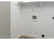 Laundry room with white walls, flooring, and hookups for a washer and dryer at 4031 W Lone Cactus Dr, Glendale, AZ 85308