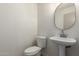 Clean powder room featuring a pedestal sink and neutral decor at 4031 W Lone Cactus Dr, Glendale, AZ 85308