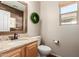 Stylish powder room featuring a decorative mirror, modern fixtures, and a clean, inviting aesthetic at 4102 E Palm Beach Dr, Chandler, AZ 85249
