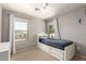 Cozy bedroom featuring a white bedframe with built-in storage drawers and a white nightstand at 4102 E Palm Beach Dr, Chandler, AZ 85249