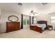 Spacious bedroom featuring a ceiling fan, carpeted floor, and an elegant wooden dresser at 4102 E Palm Beach Dr, Chandler, AZ 85249