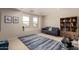Upstairs bonus room features a comfortable couch, exercise equipment, bookshelf and an area rug at 4102 E Palm Beach Dr, Chandler, AZ 85249