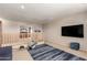 Upstairs bonus room with exercise equipment, a large flat screen TV, and comfortable seating space at 4102 E Palm Beach Dr, Chandler, AZ 85249