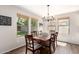 Elegant dining room with a large table, chandelier, and plenty of natural light from the surrounding windows at 4102 E Palm Beach Dr, Chandler, AZ 85249