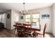 Comfortable dining room featuring a dark wood table and chairs, lit by a chandelier with abundant natural light at 4102 E Palm Beach Dr, Chandler, AZ 85249