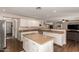 Spacious kitchen with white cabinets, granite countertops, stainless appliances, and an island with bar seating at 4102 E Palm Beach Dr, Chandler, AZ 85249