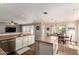 Open-concept kitchen with a center island, stainless steel appliances, and a dining area with a chandelier at 4102 E Palm Beach Dr, Chandler, AZ 85249