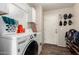 Bright laundry room features wood-look flooring, washer, dryer, and storage cabinet at 4102 E Palm Beach Dr, Chandler, AZ 85249