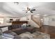 Spacious living room featuring modern ceiling fan, staircase, and seamless flow to kitchen with breakfast bar at 4102 E Palm Beach Dr, Chandler, AZ 85249