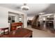 Open-concept living space showcasing wood-look flooring, staircase, piano, and seamless flow to other areas at 4102 E Palm Beach Dr, Chandler, AZ 85249