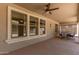 Covered patio with ceiling fan and furniture overlooking the landscaped backyard at 4102 E Palm Beach Dr, Chandler, AZ 85249